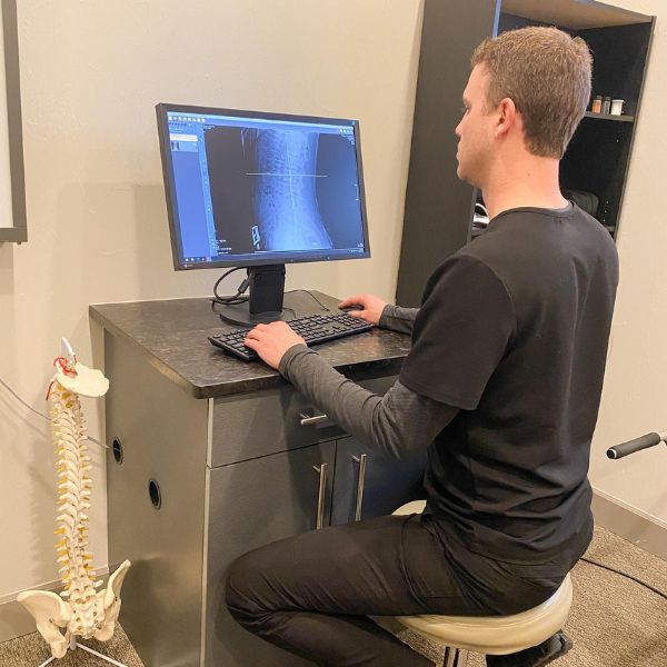 Dr Weum Analyzing Spinal X-rays - Performance Health in Helena Montana